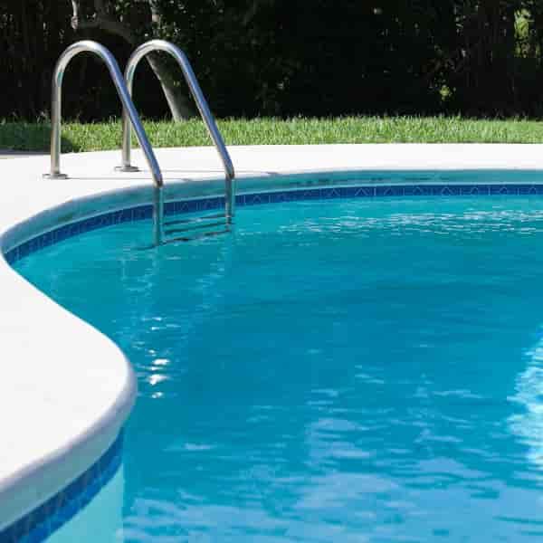 Backyard swimming pool with a steel ladder