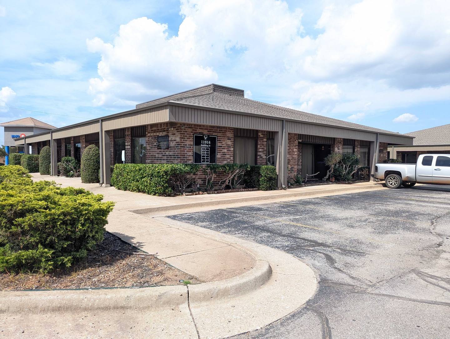 Single-story brick office building and its parking lot