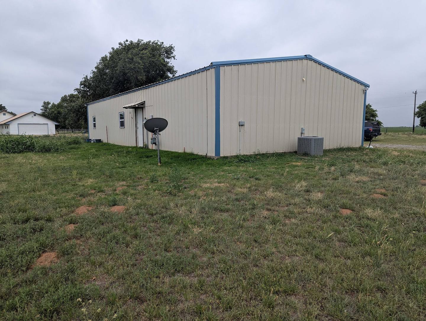 Detached metal shop building beside a home